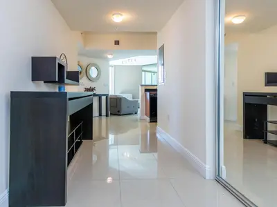 a kitchen with white walls and a black counter top at Lovely 2-Bedroom Oceanfront condo in Sunny Isles Beach