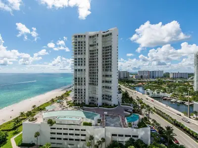 a view of a building and the beach at Lovely 2-Bedroom Oceanfront condo in Sunny Isles Beach