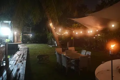 a patio with a table and chairs at night at Near Brickell, Beach & Port 10min, Style & Comfort in Miami