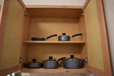 a group of pots on a shelf in a kitchen at Near Brickell, Beach & Port 10min, Style & Comfort in Miami