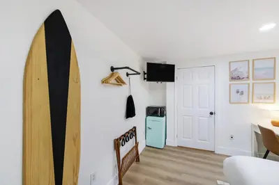 a room with a surfboard on the wall at The Victoria Hotel in Fort Lauderdale