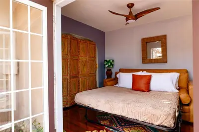 a bedroom with a bed and a ceiling fan at Hacienda de Amor - Heated pool - Hot Tub - Firepit in Fort Lauderdale