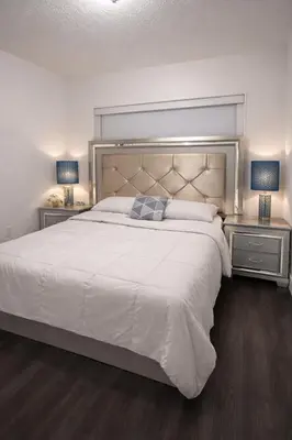 a bedroom with a large white bed with two night stands at Villa Miami Lakes 2 in Hialeah