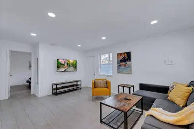 a living room with a couch and a table at Stylish 2BR Retreat in Miamis Design District in Miami