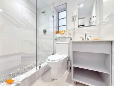 a white bathroom with a toilet and a shower at Sunny Beach Studio Steps to Ocean and Nightlife in Miami Beach