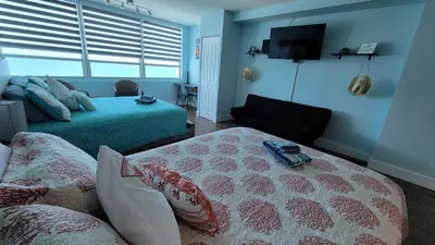 a living room with a bed and a couch at Amazing ocean view studio 14 floor Free parking in Miami Beach