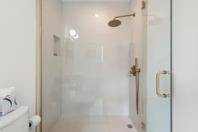 a bathroom with a shower with a glass door at The Bianco in Miami