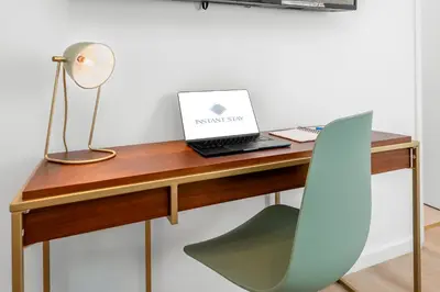a desk with a laptop and a chair on it at The Bianco in Miami
