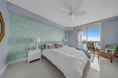 a bedroom with a bed and a view of the ocean at Waterfront 2BR Unit with Bayview Boho Style Stunning Sunset Pool Hot Tub Gym in Sunny Isles Beach