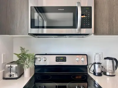 a microwave above a stove in a kitchen at SPECIAL OFFER - Luxury High Rise Downtown Miami - Bay Views and Top Amenities in Miami