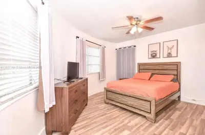 a bedroom with a bed and a ceiling fan at North Beach-Room with Private Entrance in Miami Beach