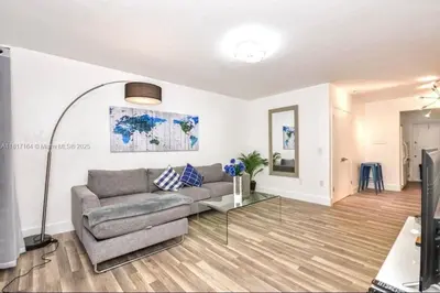 a living room with a couch and a glass table at North Beach-Room with Private Entrance in Miami Beach