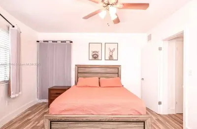a bedroom with a bed and a ceiling fan at North Beach-Room with Private Entrance in Miami Beach
