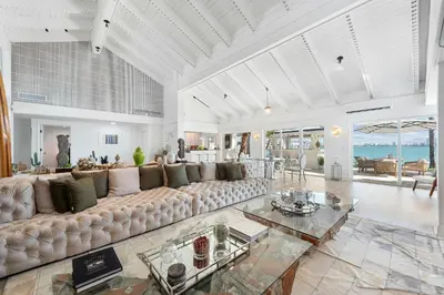 a large living room with a large couch and a table at Villa Tropique in Miami Beach