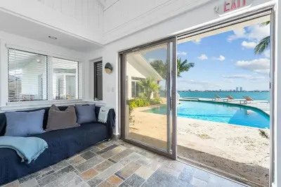 a living room with a couch and a view of the ocean at Villa Tropique in Miami Beach