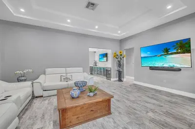 a living room with a couch and a tv on a wall at Miami Sombra - Prime Location-Parkfront- Den-Gazebo in Miami