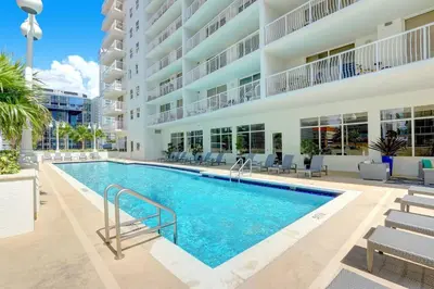 an image of a swimming pool in front of a building at Stylish Brickell Condo with Balcony and Parking in Miami