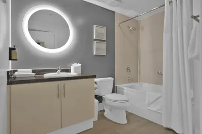 a bathroom with a sink toilet and a mirror at Modern Comfort Steps from the Ocean Breeze in Miami