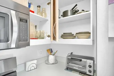 a kitchen with a microwave oven and a counter top at Sunny Getaway, Pool and Parking in Miami
