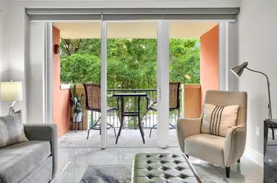 a living room with a couch and a table and chairs at Palm Oasis, Pool and Free Parking in Miami