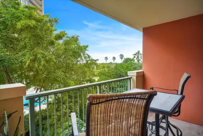 a table and chair on a balcony with a view at Palm Oasis, Pool and Free Parking in Miami