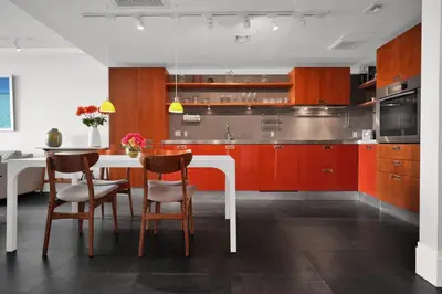 a kitchen with red cabinets and a white table and chairs at Coastal Elegance and Luxury by the Water in Miami