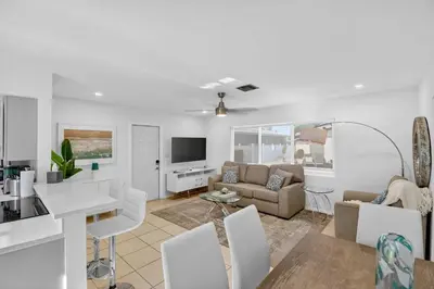 a living room with a couch and a table at Victoria Park's Secret Estate in Fort Lauderdale