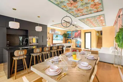 a dining room and kitchen with a table and chairs at 3BR Vibrant Havana Villa in Miami, Pool, Grill, Backyard in Miami