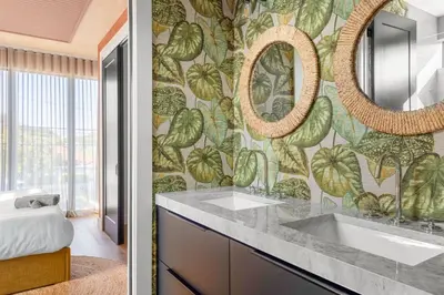 a bathroom with a sink and a wall mural at 3BR Vibrant Havana Villa in Miami, Pool, Grill, Backyard in Miami