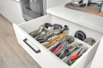 a white drawer filled with lots of utensils at Home Away From Home in Coconut Grove in Miami