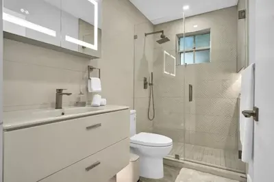 a bathroom with a toilet and a sink and a shower at Home Away From Home in Coconut Grove in Miami
