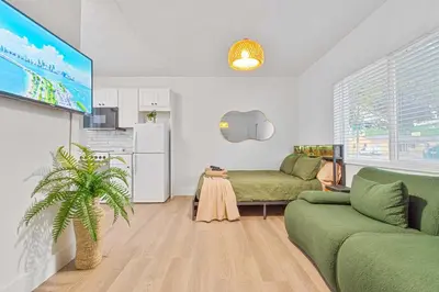 a living room with a couch and a tv at Luxury Miami Studio Close to Wynwood & Downtown in Miami