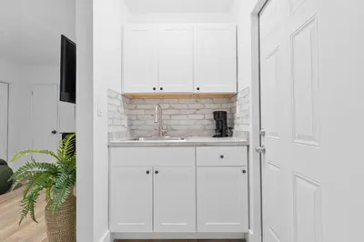 a kitchen with white cabinets and a sink at Luxury Miami Studio Close to Wynwood & Downtown in Miami