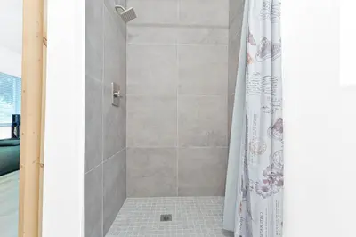 a shower with a shower curtain in a bathroom at Luxury Miami Studio Close to Wynwood & Downtown in Miami
