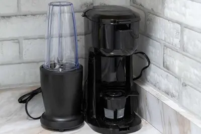 a black blender sitting on a counter next to a wall at Luxury Miami Studio Close to Wynwood & Downtown in Miami