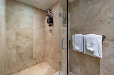 a bathroom with a shower with a glass door at Lumina Residences 2BR Skyline Escape in Miami Beach