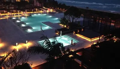 a view of a pool at night with lights at Lumina Residences 2BR Skyline Escape in Miami Beach