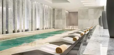 a swimming pool with a row of chairs in a room at Fontainebleau Sorrento Jr suite in Miami Beach