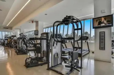 a gym with a bunch of tread machines in a room at Fontainebleau Sorrento Jr suite in Miami Beach