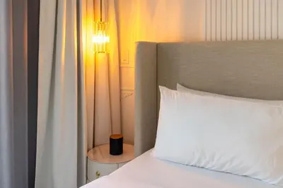 a bedroom with a bed with a white pillow and a lamp at Parisian Vibe in Design District Miami with Private Pool BBQ Spacious Backyard in Miami