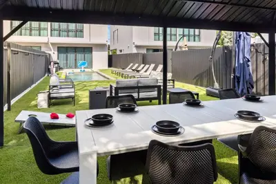 a patio with tables and chairs and a pool at Parisian Vibe in Design District Miami with Private Pool BBQ Spacious Backyard in Miami