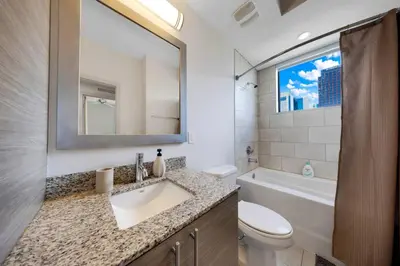 a bathroom with a sink and a toilet and a tub at Aqua Luxe in DTWN 3 Min From Las Olas in Fort Lauderdale