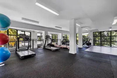 a gym with treadmills and elliptical machines at Isla Blue in DTWN 3 Min From Las Olas in Fort Lauderdale