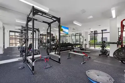 a gym with a lot of treadmills and machines at Isla Blue in DTWN 3 Min From Las Olas in Fort Lauderdale