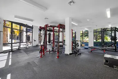 a gym with several treadmills and machines at Casa Palmera in DTWN 3 Min From Las Olas in Fort Lauderdale