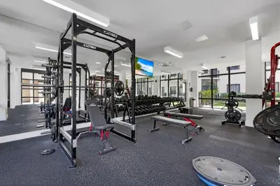a gym with several treadmills and machines at Casa Palmera in DTWN 3 Min From Las Olas in Fort Lauderdale
