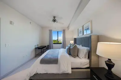 a white bedroom with a bed and a window at Prestige Living in DTWN 3 Min From Las Olas in Fort Lauderdale