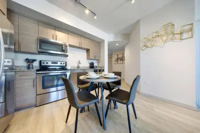 a kitchen with a table and chairs in a room at Modern Palmera in DTWN 3 Min From Las Olas in Fort Lauderdale