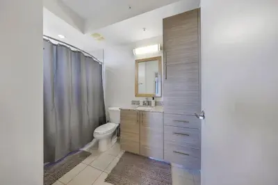 a bathroom with a toilet and a sink at Modern Palmera in DTWN 3 Min From Las Olas in Fort Lauderdale