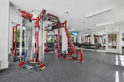 a gym with red equipment and tread machines at The Serenity in DTWN 3 Min From Las Olas in Fort Lauderdale